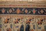 Vintage Serapi design border close-up with navy, terra cotta, ivory floral vinery and fringe.
