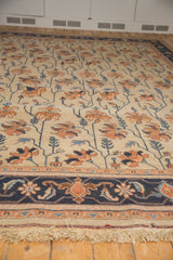 Vintage Indian Soumac carpet border with navy, terracotta, sky blue floral design and ivory fringe.