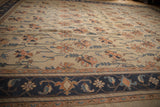 Vintage Indian Soumac rug border with navy, terra cotta, and ivory floral vinery.