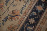 Vintage Indian Soumac carpet detail: antique ivory field, terra cotta flora, navy border.