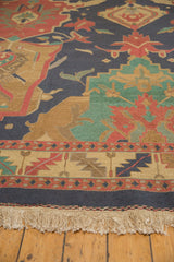 Vintage hand-woven Soumac carpet detail: large geometric patterns, serrated leaf border, fringe.