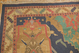 Intricate serrated border with geometric arabesques in red, blue, and teal on Soumac rug.