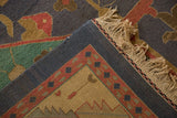 Detail of hand-woven Soumac back, deep royal blue selvage, piled red and teal geometric motifs.