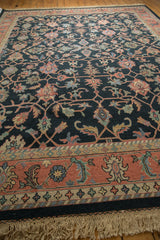 Angled view of vintage hand-woven Soumac textile with dusty navy and blush palmette vinery.
