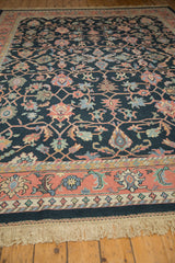 Vintage Indian rug border in dusty blush, featuring sky blue motifs and soft ivory fringe.