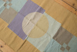 Abstract geometric Kilim rug with circles, squares in sand, beige, powder blue, lavender.