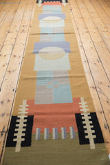 Hand woven contemporary kilim texture with geometric shapes in sand, blue, and red.