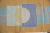 Contemporary Kilim rug: abstract pinwheel design with circles, rectangles in sand and blues.