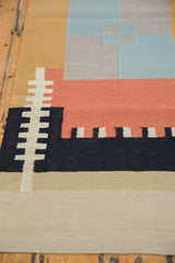 Abstract geometric patterns in sand, black, madder root red, and powder blue kilim runner.