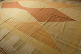 Contemporary Kilim carpet's geometric argyle diamonds in beige, saffron, and rust tones.