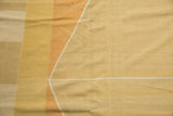 Contemporary hand woven Kilim rug detail, geometric argyle pattern in saffron, rust, and neutral.