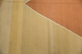 Modern geometric detail of vintage Kilim rug featuring diagonal ivory, beige, and deep copper.
