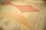 Contemporary Kilim rug with argyle-inspired diamond shapes in pale saffron and rust tones.