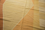 Argyle inspired geometric diamond pattern on a Contemporary Kilim carpet in beige, sand, and rust.