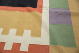 Contemporary Kilim carpet detail showing abstract design of madder root, sand, ivory, and green.