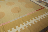 Contemporary Kilim rug showing white tracked motif on gold and banded sections.
