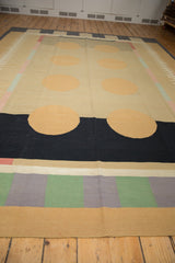 Segment of hand woven contemporary kilim with abstract peach circles, black band, and banded border.