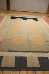 Contemporary Kilim rug with geometric border bands in charcoal, beige, and pale red.