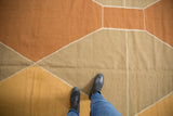 Contemporary kilim carpet featuring Argyle diamond pattern in bronze, gold, and sand.