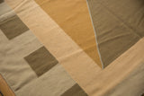 Contemporary Kilim rug with geometric argyle-inspired pattern in bronze, sand, and beige tones.