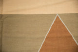 Geometric diamond pattern with bronze, dusty ivory, and beige-gray on a contemporary Kilim.