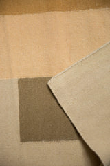 Flatweave texture and original side cord selvage of a contemporary Kilim rug, sand and bronze.