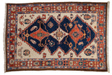 Vintage Northwest Persian carpet with triple navy blue medallion, ivory field, and rust floral motifs.