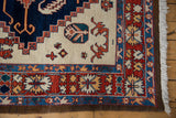 Vintage Northwest Persian rug corner, showcasing stylized floral designs on madder red border and ivory field.