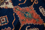 Elongated rust medallion with mallard green florals on abrashed navy blue ground.