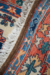 Hand-knotted vintage Persian carpet fringe, selvage, and rust, navy, ivory floral pattern.