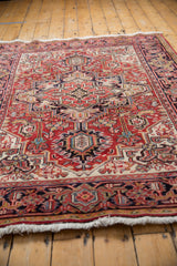 Low angle highlighting the even pile and intricate geometric design of a vintage Heriz rug.
