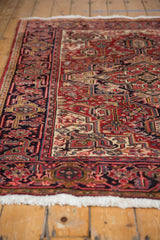 Side view of a vintage Heriz rug showing the dense, even pile and intricate geometric border.
