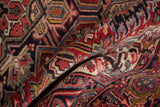Softly folded vintage Heriz rug showing the even wool pile and intricate geometric details.