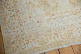 Intact side cord selvage and fringe on a vintage Kerman rug with ivory florals.