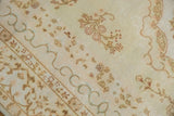 Close-up of hand-knotted vintage Kerman design rug showing ivory field with Rococo floral sprays.