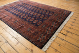 Intricate rust and navy blue geometric border and plush wool pile on a fine vintage Bokhara carpet.