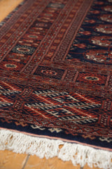 Close view of the lustrous, plush wool pile and ivory fringe of a Bokhara rug.