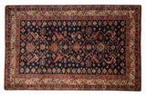 Vintage Romanian Kuba design carpet, deep navy, geometric floral diamond motifs, colorful rhythmic border.