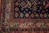 Colorful rhythmic geometric main border and playful diamond motifs on the vintage Kuba carpet.
