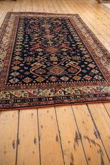 Vintage Romanian Kuba design carpet showcasing a vibrant geometric main border with secure side cord.