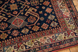 Vintage Romanian Kuba carpet's rhythmic geometric border with navy, red, and cream motifs.