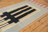 Detail of the interlocked border and abstract geometric pattern on a Kilim runner.