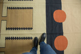 Contemporary Kilim rug showcasing abstract geometric sand, dusty navy, and madder root red patterns.