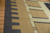 Vintage Contemporary Kilim rug side edge, featuring a dark gray stepped border and beige geometric motifs.
