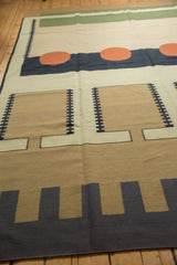 Detail of the contemporary Kilim's blocky, interlocked geometric pattern in sand and navy blue.