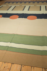 Abstract striped pattern on a vintage Kilim, featuring beige, mallard green, and tan.