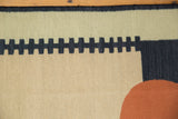 Curved madder root red and dusty navy geometric motif on a sand and mallard green kilim.