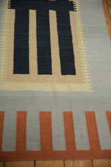 Geometric blocks and stepped design in charcoal, silver, terra cotta on a contemporary Kilim.