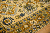 Siberian Caucasian rug detail showcasing saffron, dark blue, and sage geometric floral patterns.