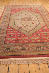 Intact natural fringe and geometric patterned border of the vintage Chinese Khotan carpet.